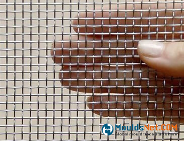 A hand is holding a piece of plain weave stainless steel woven wire cloth.