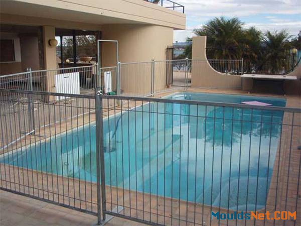 Several temporary pool fencing panels are surrounding the private villa swimming pool.