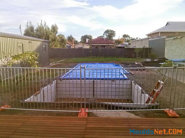 Temporary pool fencing are enclosing a pool co<em></em>nstruction site.