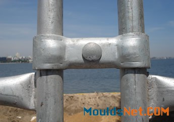 A piece of hot dipped galvanized welded portable fence is installed on two fence posts.