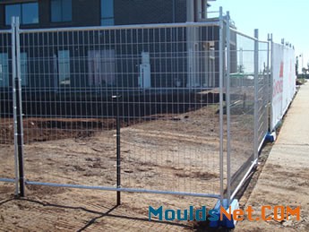 Welded portable fences are surrounding at the co<em></em>nstruction site.