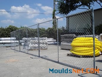 Chain l<em></em>ink portable fences are installed in the factory and several equipments in it.