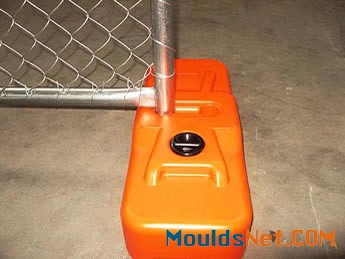 An orange plastic chain l<em></em>ink portable fence feet is installed on the fence panel.