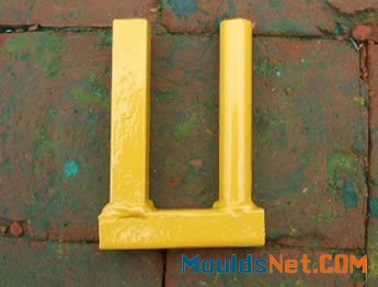 A yellow top coupler with round and square tubular legs on the ground.