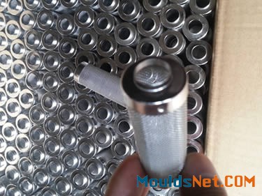 Many stainless steel woven cylindrical filter elements in a carton.
